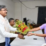 A girl gives flower bouquet to Dr Anindya Bose